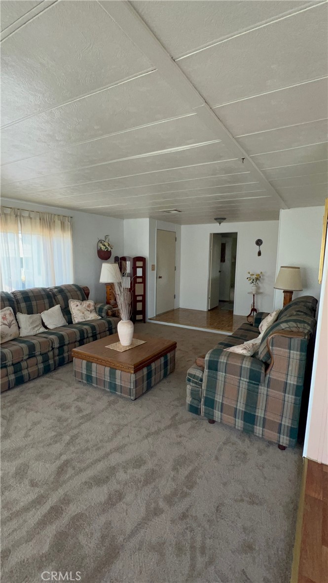 650 South Rancho Santa Fe Road, Unit 106 San Marcos, CA 92078 - Photo 53 of 55 a living room with furniture a window and a table