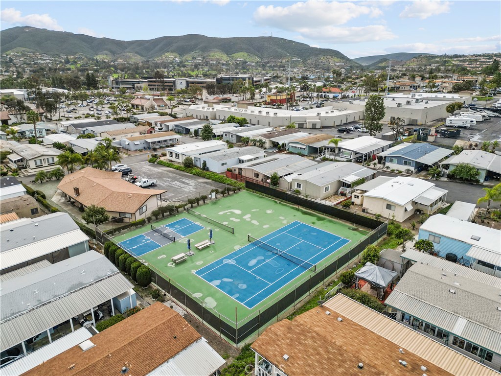 650 South Rancho Santa Fe Road, Unit 106 San Marcos, CA 92078 - Photo 6 of 55 an aerial view of a tennis ground and a mountain view in back