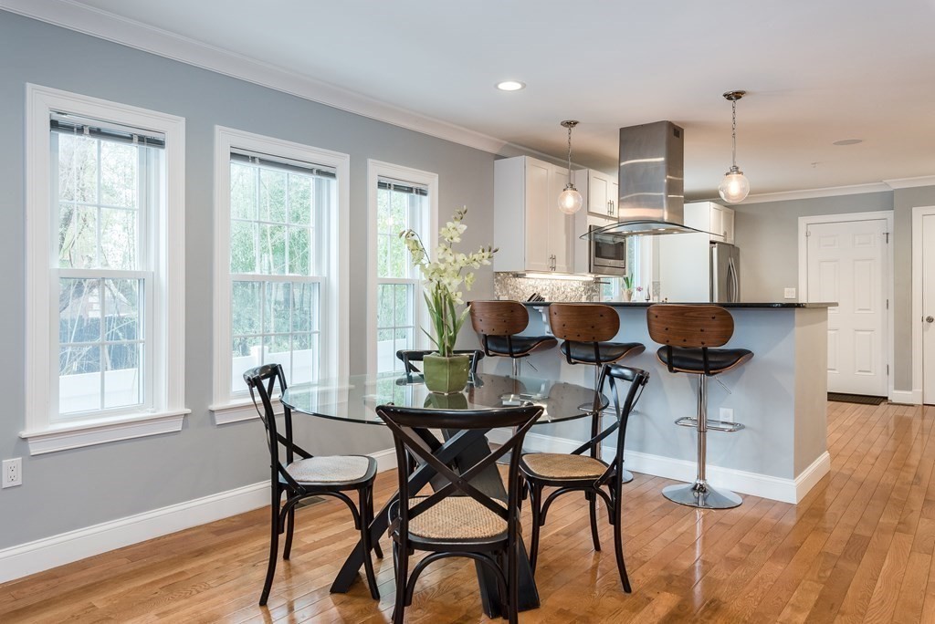 a view of a dining room with furniture and wooden floor