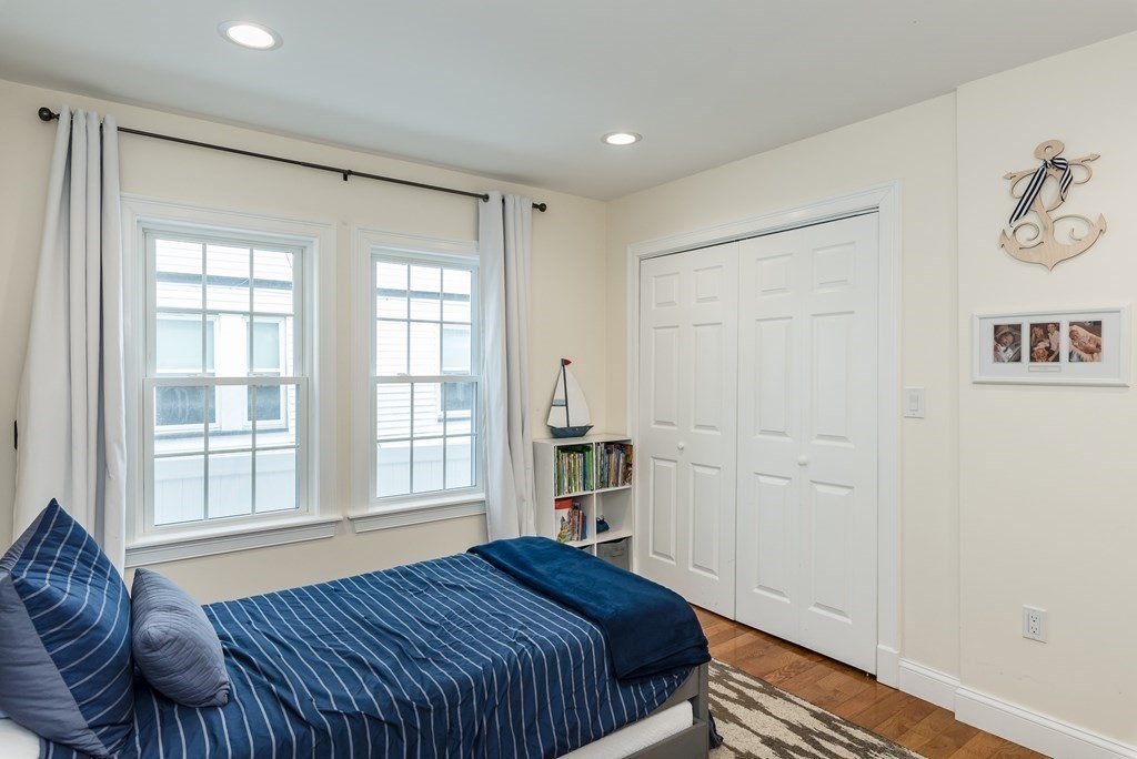 143 Williams Street, Unit 1 Boston, MA 02130 - Photo 12 of 19 a bedroom with a bed and wooden floor