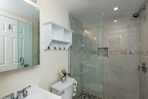 a bathroom with a shower a toilet and a sink