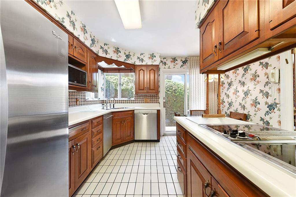 154 Gilda Avenue Pittsburgh, PA 15217 - Photo 11 of 25 a kitchen with a sink stove top oven and cabinets