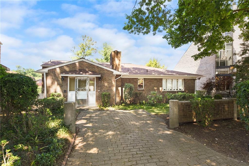 154 Gilda Avenue Pittsburgh, PA 15217 - Photo 24 of 25 a front view of a house with a garden