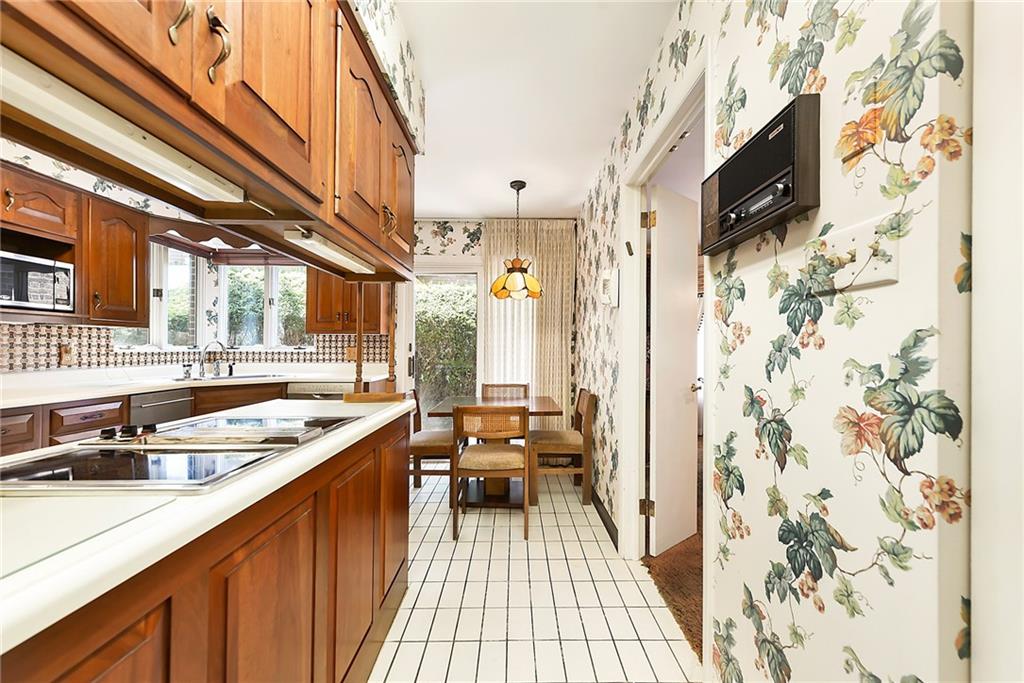 154 Gilda Avenue Pittsburgh, PA 15217 - Photo 9 of 25 a kitchen with stainless steel appliances a stove a sink and a refrigerator