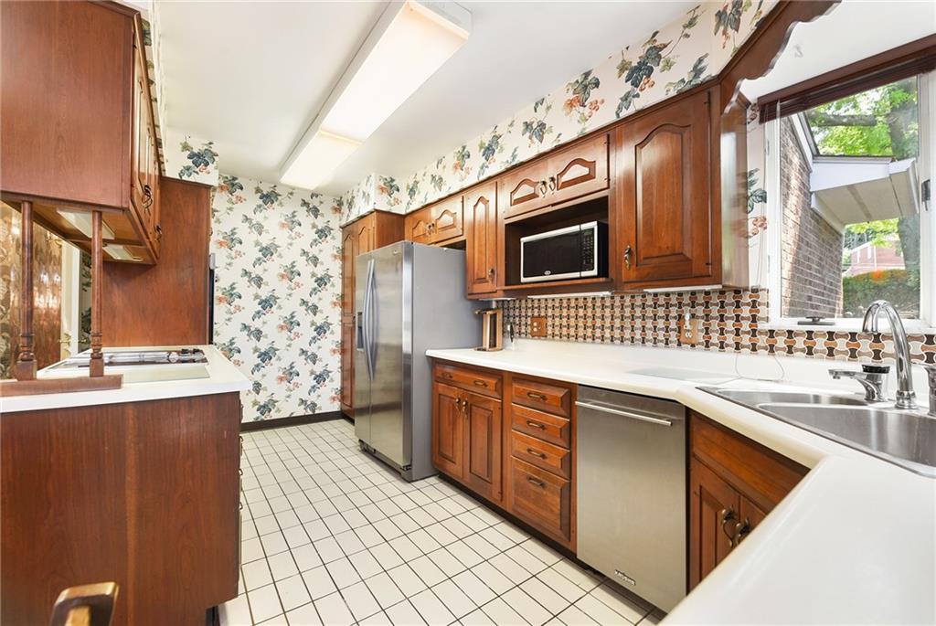 154 Gilda Avenue Pittsburgh, PA 15217 - Photo 10 of 25 a kitchen with stainless steel appliances granite countertop a sink and cabinets