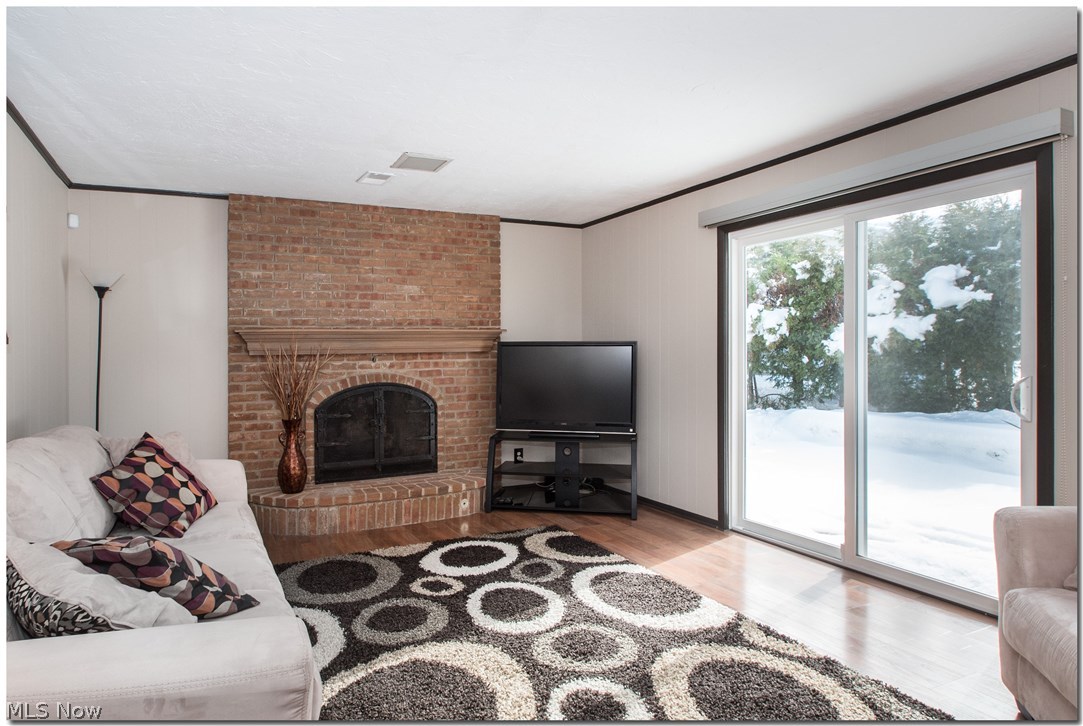 6546 Hansford Road Cleveland, OH 44124 - Photo 12 of 29 Family Room with brick fireplace and new glass sliding door out to patio.