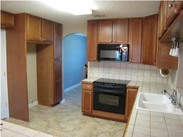 5450 Ponte Verde Road Pensacola, FL 32507 - Photo 7 of 19 Maple Cabinets, Tile Counters, Tile Floor