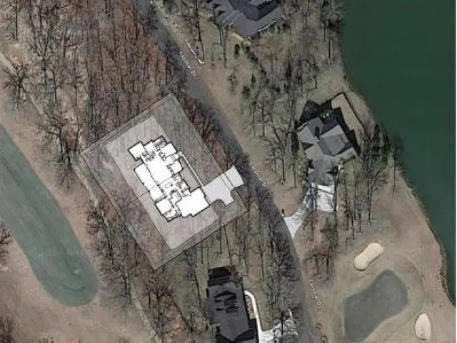 a view of a swimming pool with a garden and trees