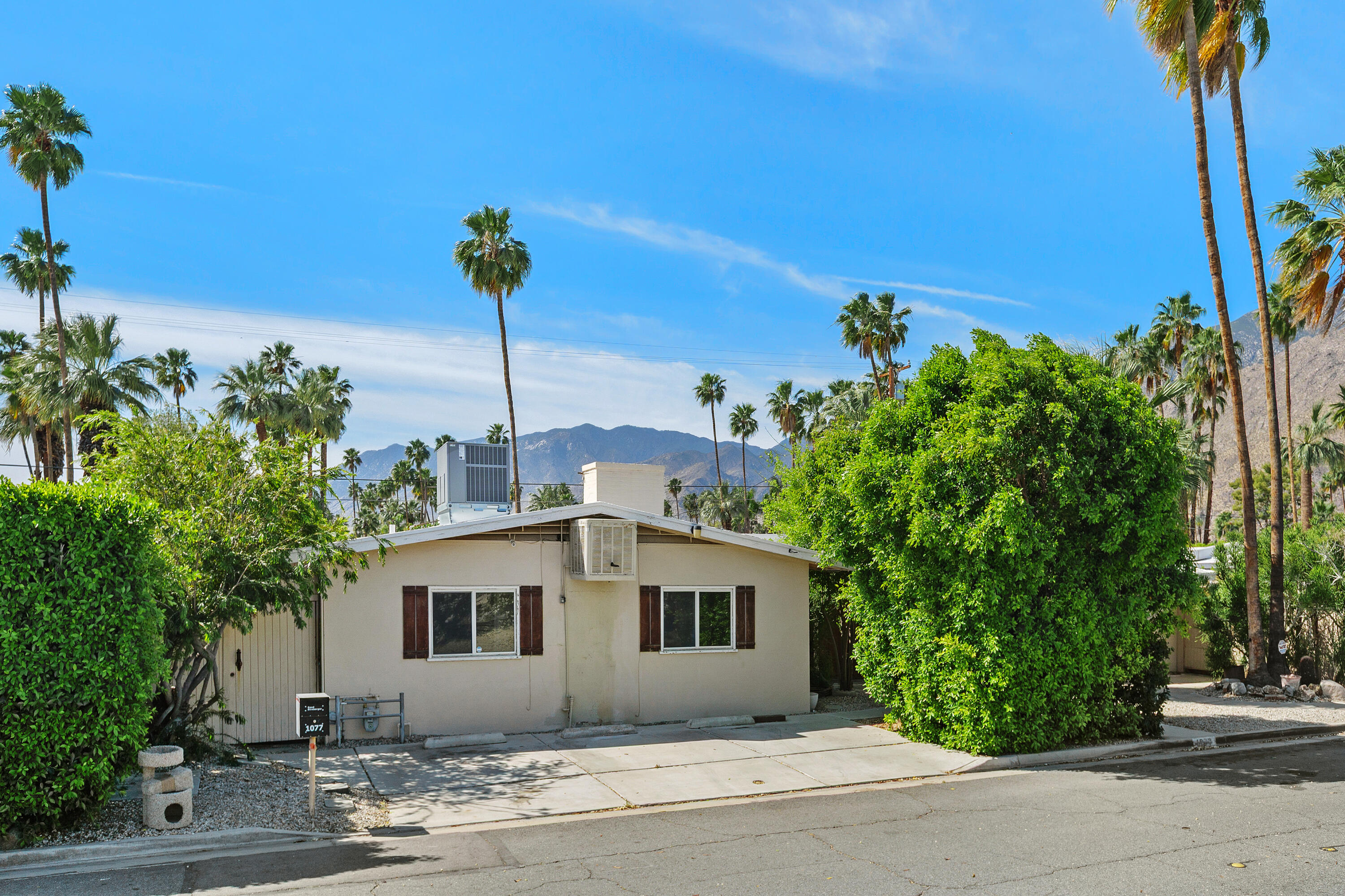 1077 South Riverside Drive Palm Springs, CA 92264 - Photo 6 of 35 a front view of a house with a yard