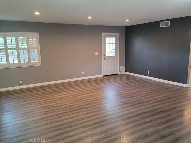 a kitchen with stainless steel appliances kitchen island granite countertop a refrigerator a stove top oven a sink and dishwasher