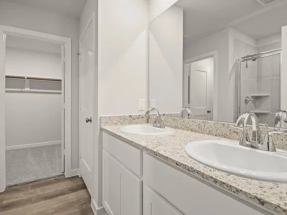 a bathroom with double sink and a mirror