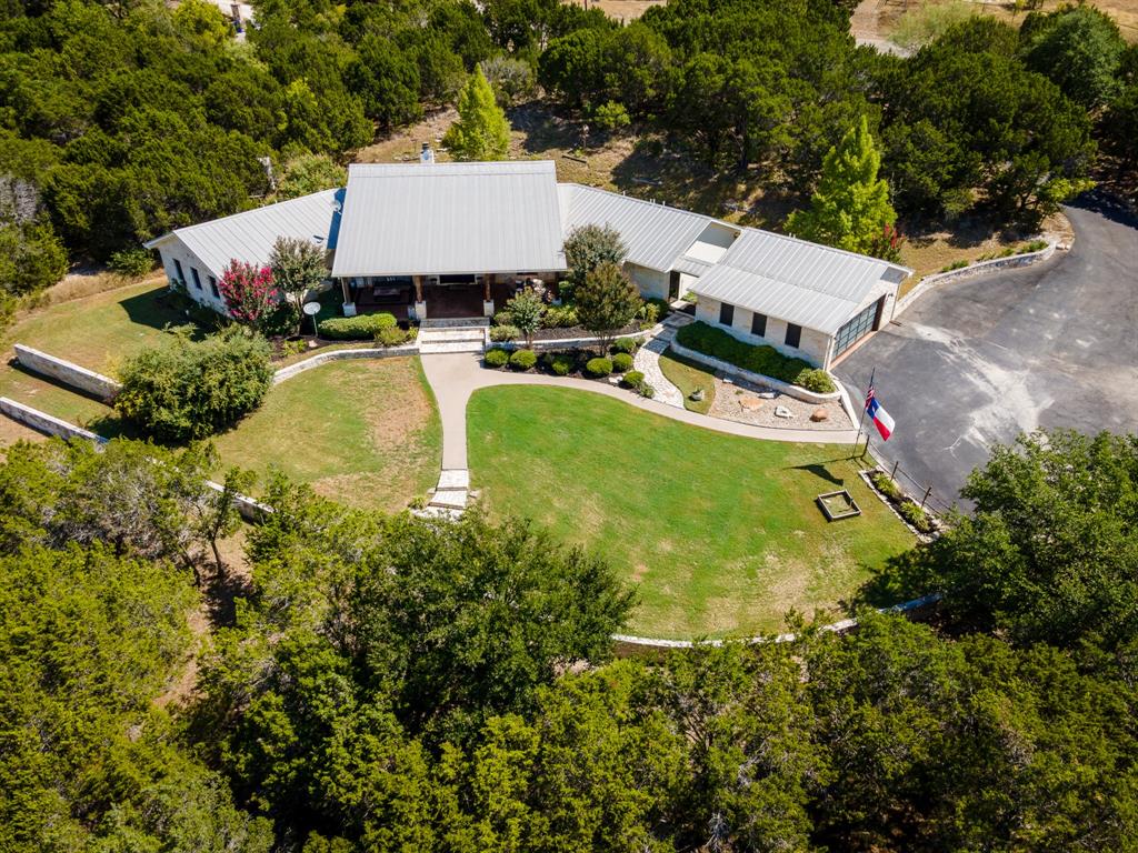 2244 County Road 328 Glen Rose, TX 76043 - Photo 1 of 1 an aerial view of a house with swimming pool and patio