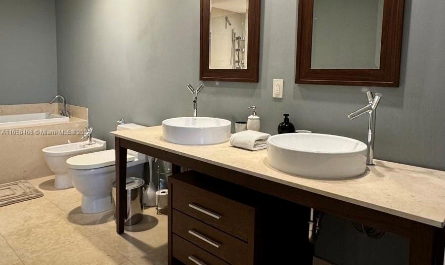 495 Brickell Avenue, Unit 4902 Miami, FL 33131 - Photo 11 of 24 a bathroom with a sink and a mirror