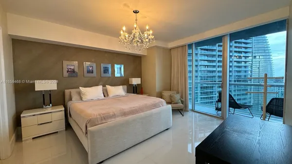 a bed room with a bed and a chair