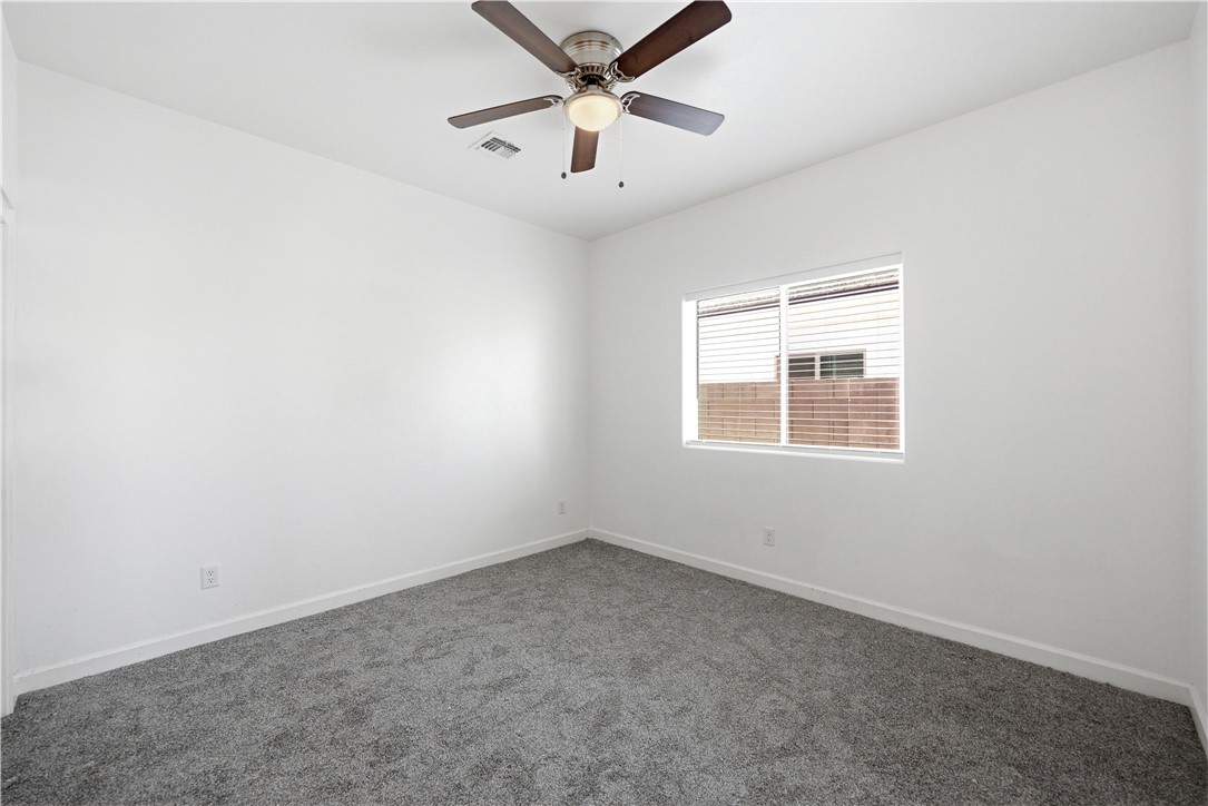 3546 North Skylark Road Kingman, AZ 86409 - Photo 11 of 30 an empty room with a window and a fan