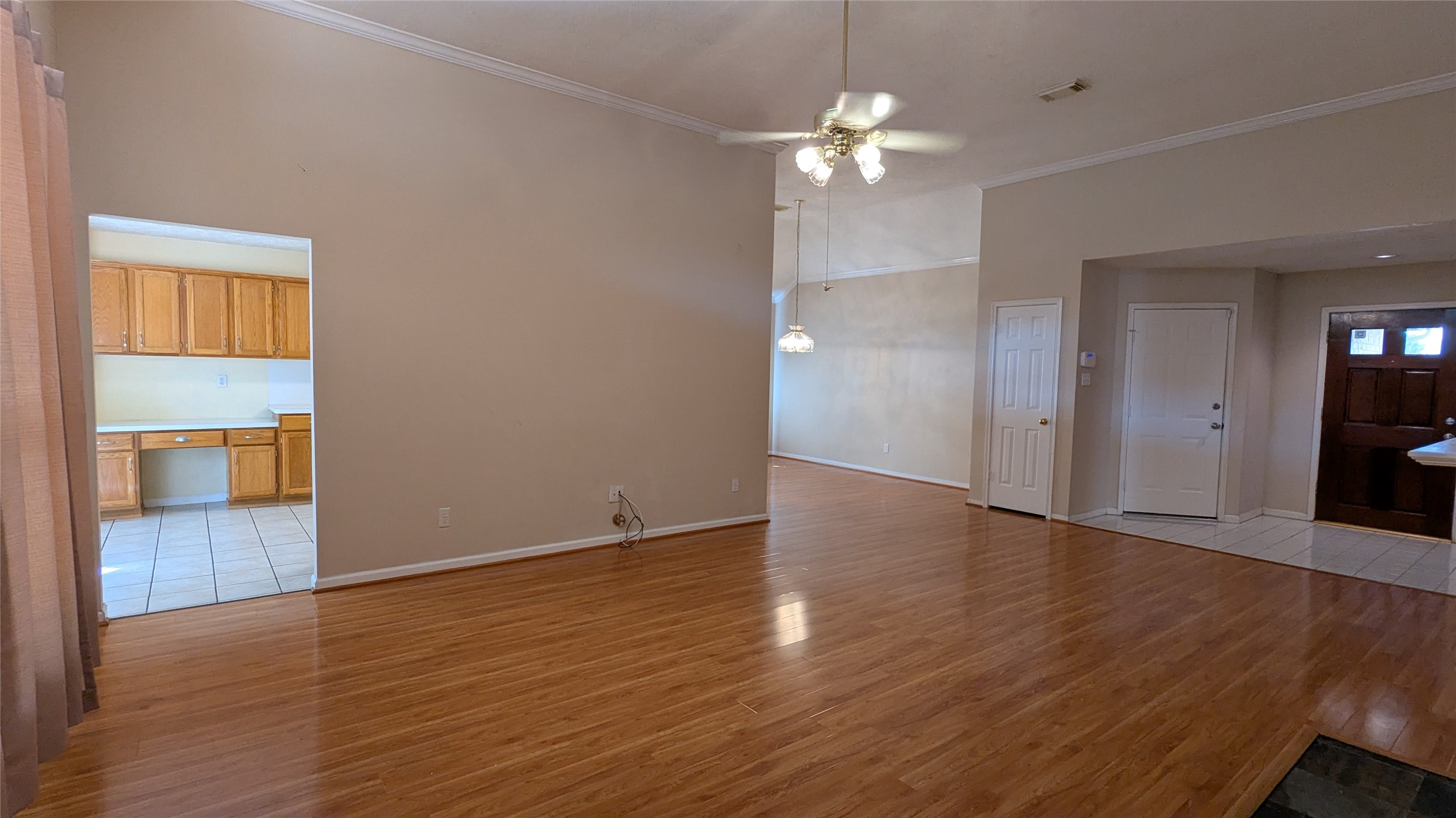 a view of an empty room with wooden floor