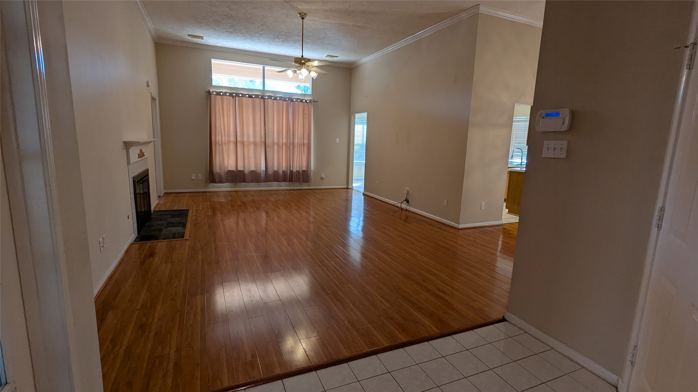 18319 North Willow Bluff Road Katy, TX 77449 - Photo 2 of 23 an empty room with wooden floor and windows