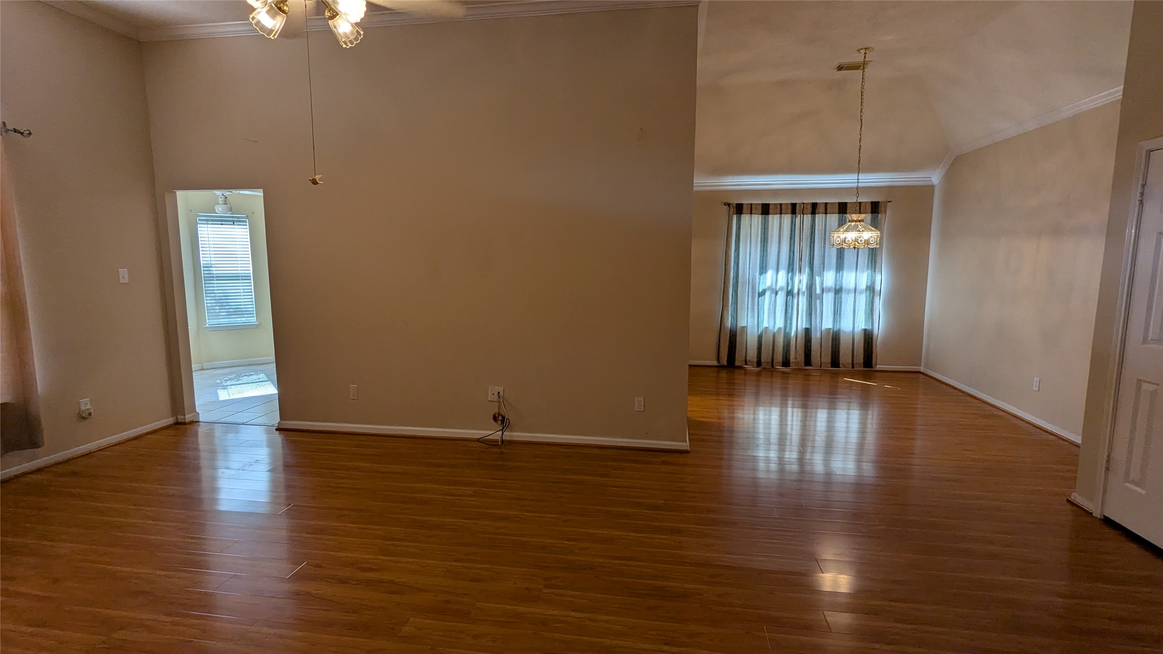 18319 North Willow Bluff Road Katy, TX 77449 - Photo 3 of 23 an empty room with wooden floor and windows