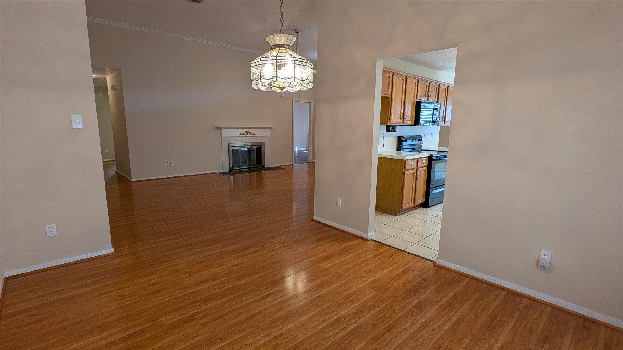 18319 North Willow Bluff Road Katy, TX 77449 - Photo 4 of 23 a view of a room with wooden floor and chandelier