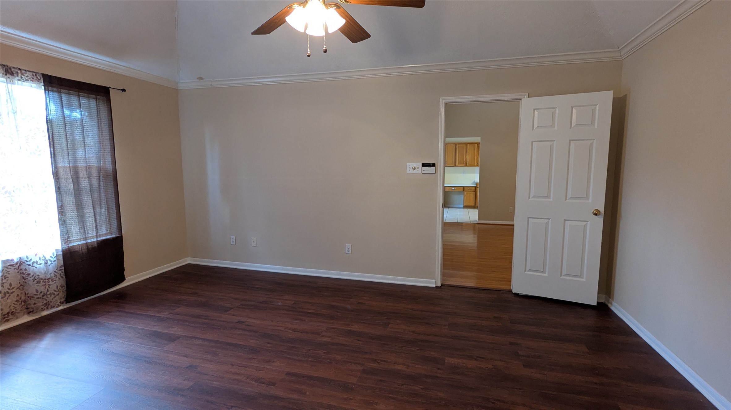 18319 North Willow Bluff Road Katy, TX 77449 - Photo 5 of 23 an empty room with wooden floor cabinet and windows