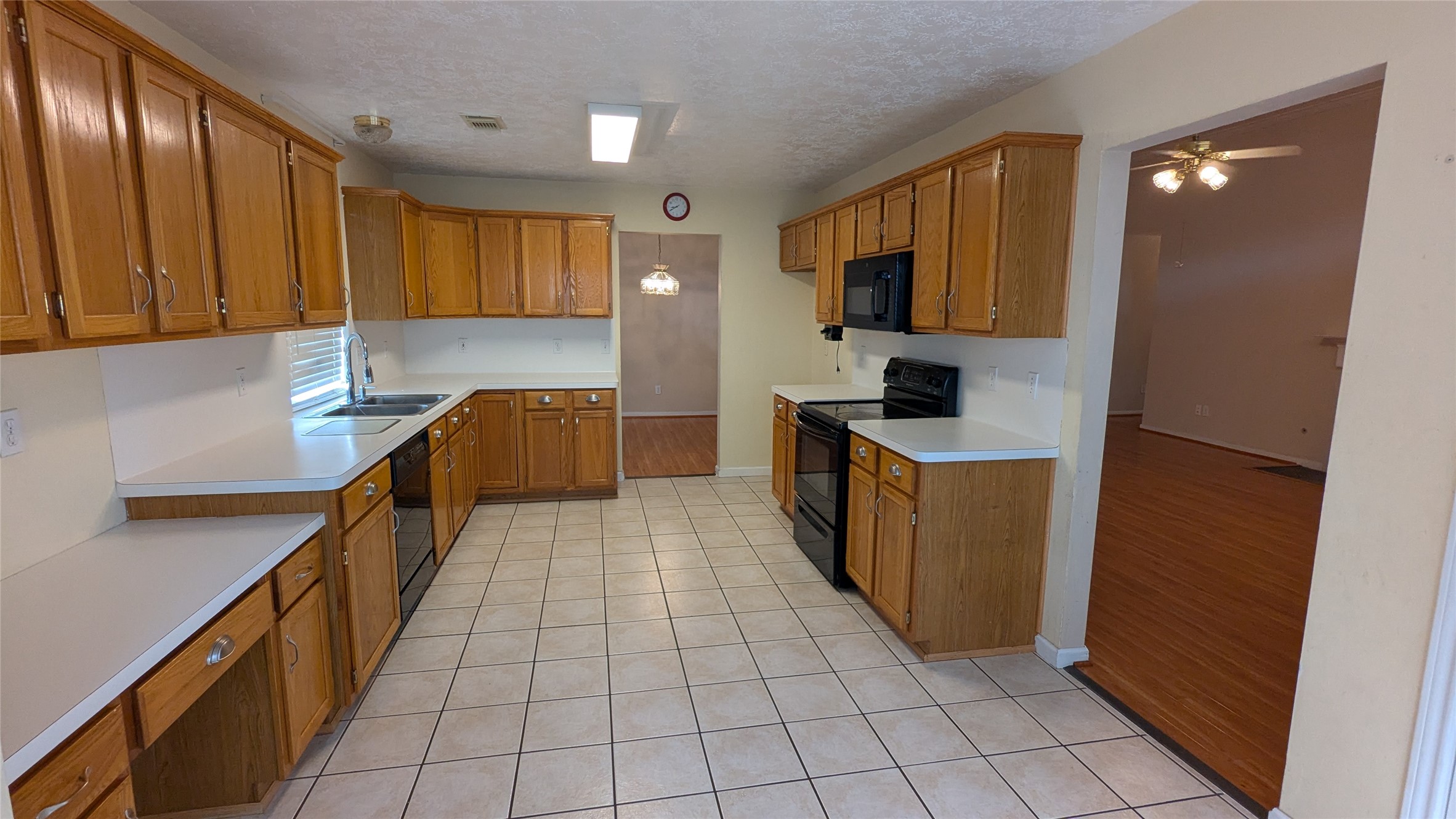 18319 North Willow Bluff Road Katy, TX 77449 - Photo 9 of 23 a kitchen with stainless steel appliances granite countertop a sink counter space cabinets and a large window