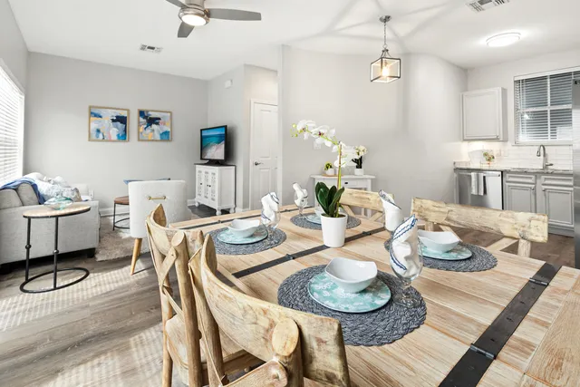 a dining room with furniture and wooden floor