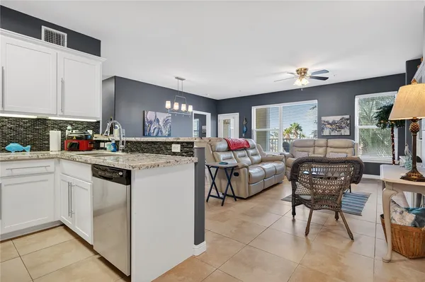 a kitchen that has a lot of cabinets in it and appliances