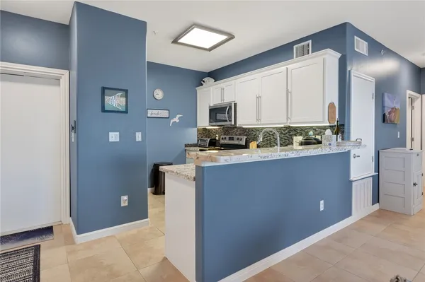 a kitchen with stainless steel appliances a refrigerator and a stove
