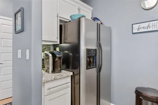 a kitchen with stainless steel appliances granite countertop a refrigerator and a stove