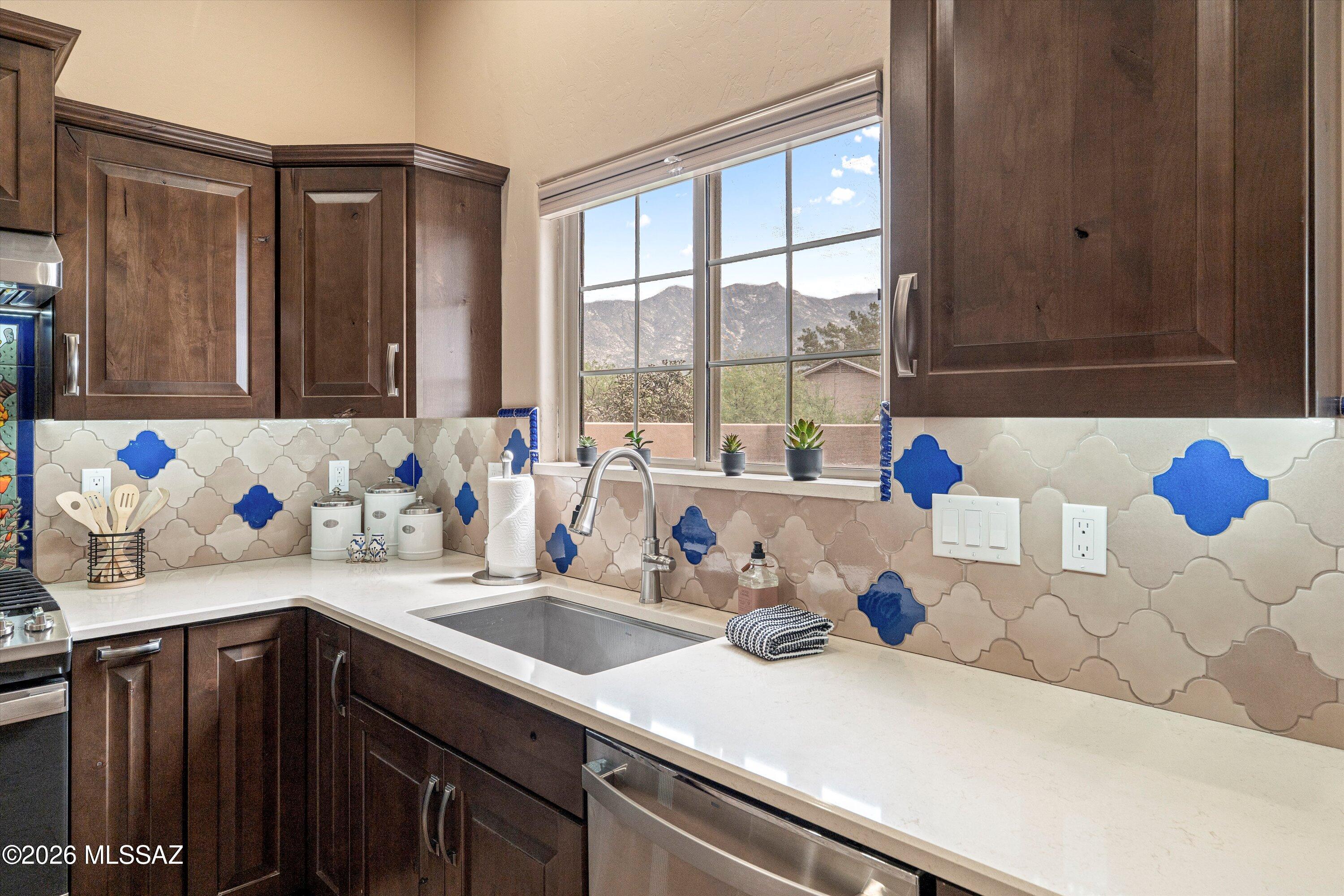 4760 East Wagon Train Road Tucson, AZ 85739 - Photo 3 of 38 a kitchen with a sink cabinets and a window