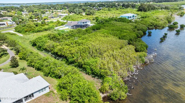 an aerial view of a house with yard