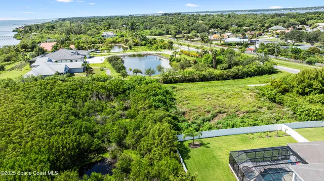 an aerial view of residential houses with outdoor space and swimming pool