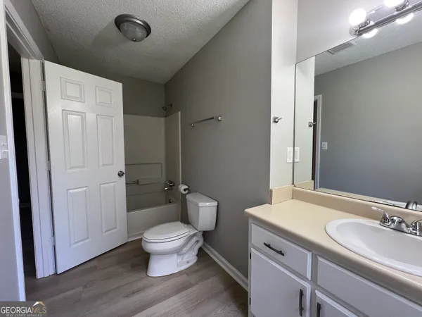 a bathroom with a double vanity sink toilet and shower