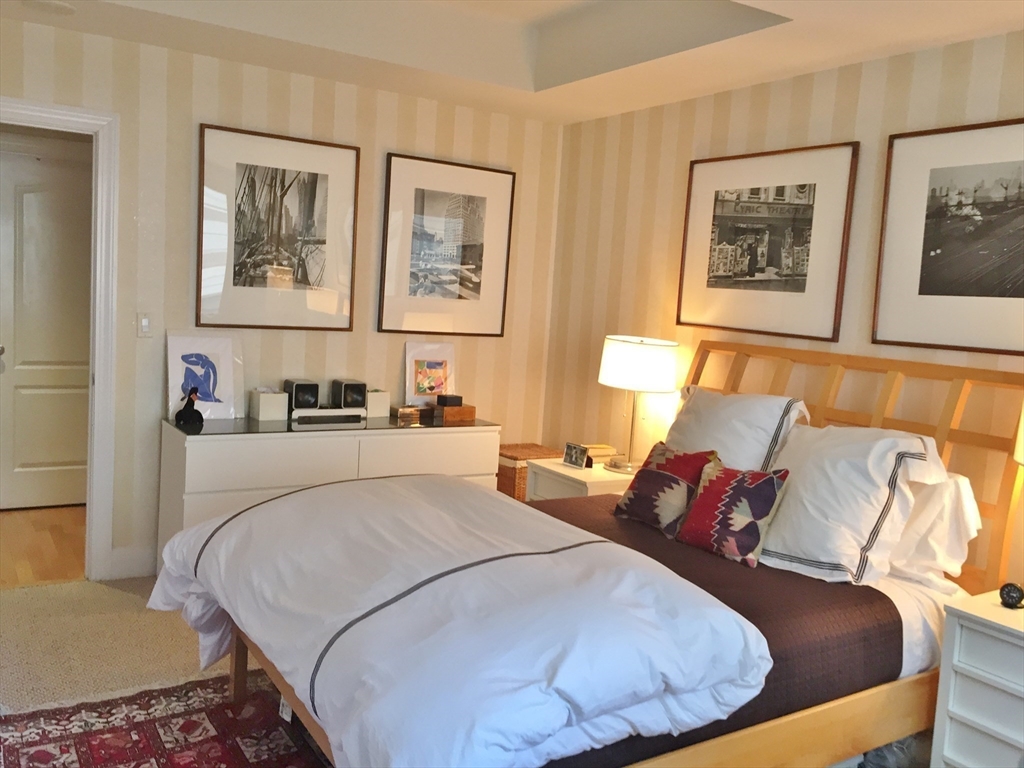 1 Huntington Avenue, Unit 405 Boston, MA 02116 - Photo 6 of 12 a bed room with a bed and painting on the wall