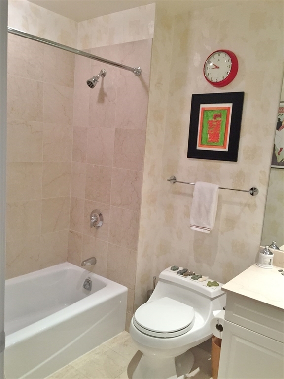 1 Huntington Avenue, Unit 405 Boston, MA 02116 - Photo 7 of 12 a bathroom with a sink a toilet and a bathtub