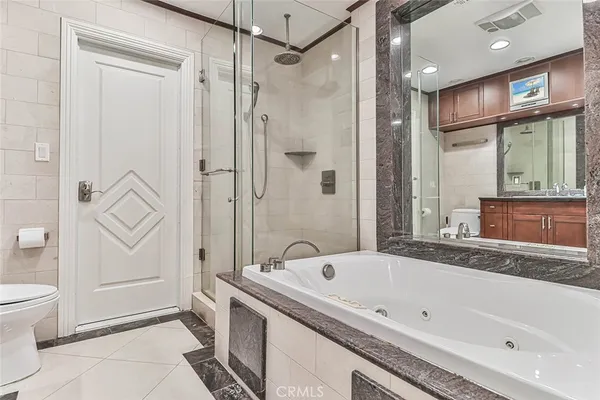 a bath tub sitting next to a white sink and vanity