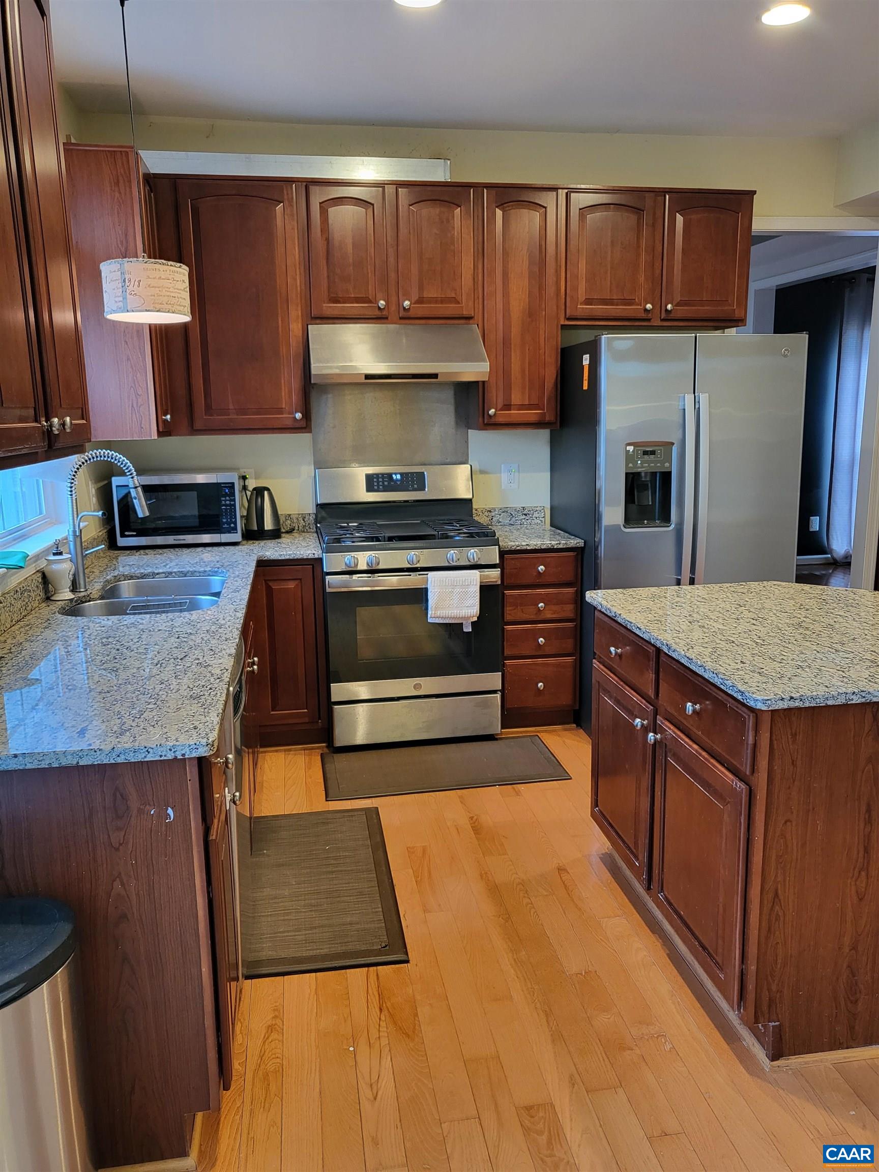 712 Rainier Road Charlottesville, VA 22903 - Photo 3 of 11 a kitchen with stainless steel appliances granite countertop a stove a sink and a refrigerator