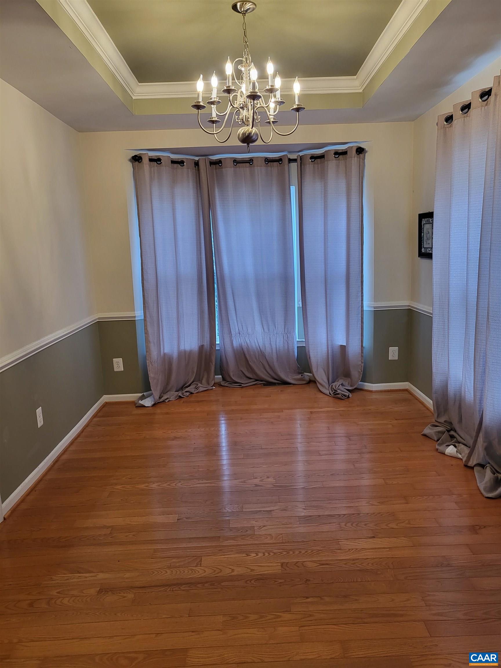 712 Rainier Road Charlottesville, VA 22903 - Photo 4 of 11 a view of a room with wooden floor and chandelier