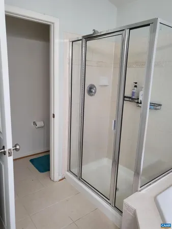 a bathroom with a glass door shower