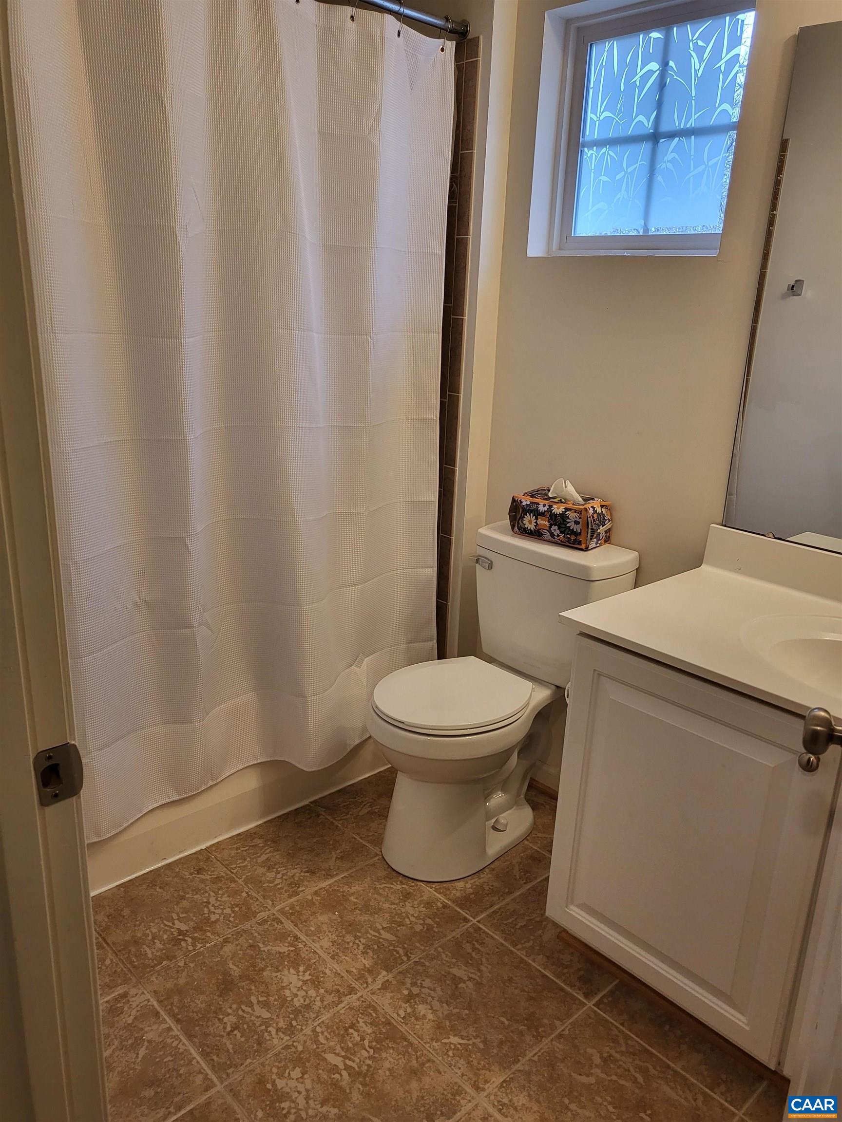 712 Rainier Road Charlottesville, VA 22903 - Photo 8 of 11 a bathroom with a toilet and a shower curtain