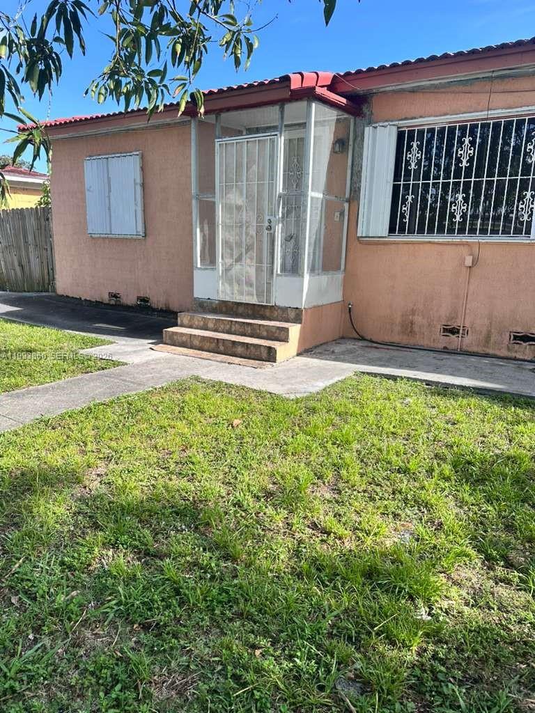 576 Northwest 147th Street, Unit 576 Miami, FL 33168 - Photo 13 of 18 front view of a house with a yard