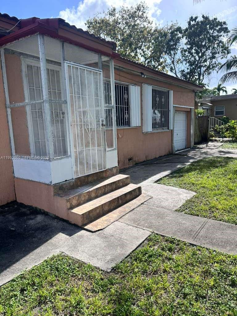 576 Northwest 147th Street, Unit 576 Miami, FL 33168 - Photo 14 of 18 a backyard of a house with table and chairs