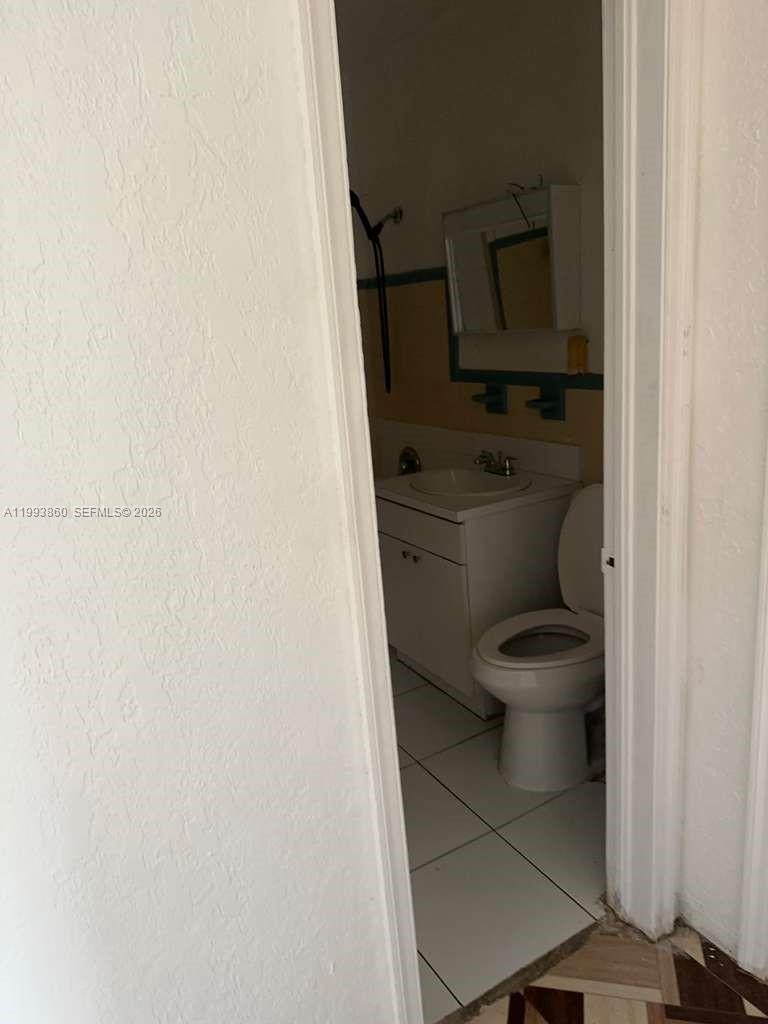 576 Northwest 147th Street, Unit 576 Miami, FL 33168 - Photo 17 of 18 a bathroom with a toilet and a sink