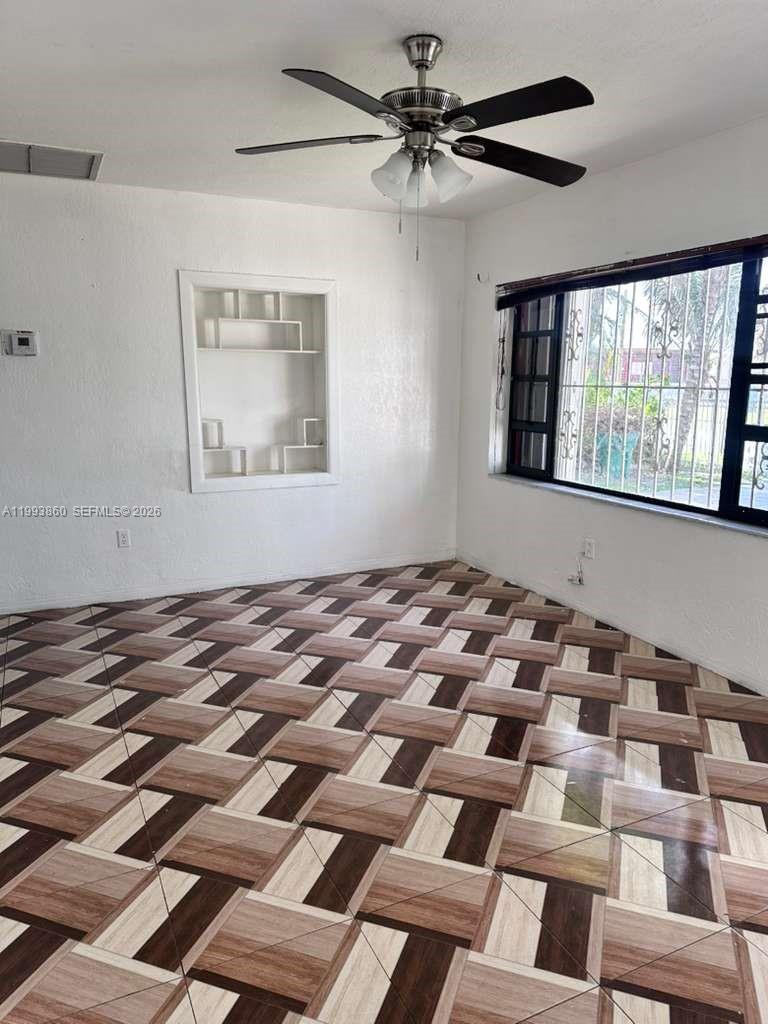 576 Northwest 147th Street, Unit 576 Miami, FL 33168 - Photo 2 of 18 a view of a bedroom with windows