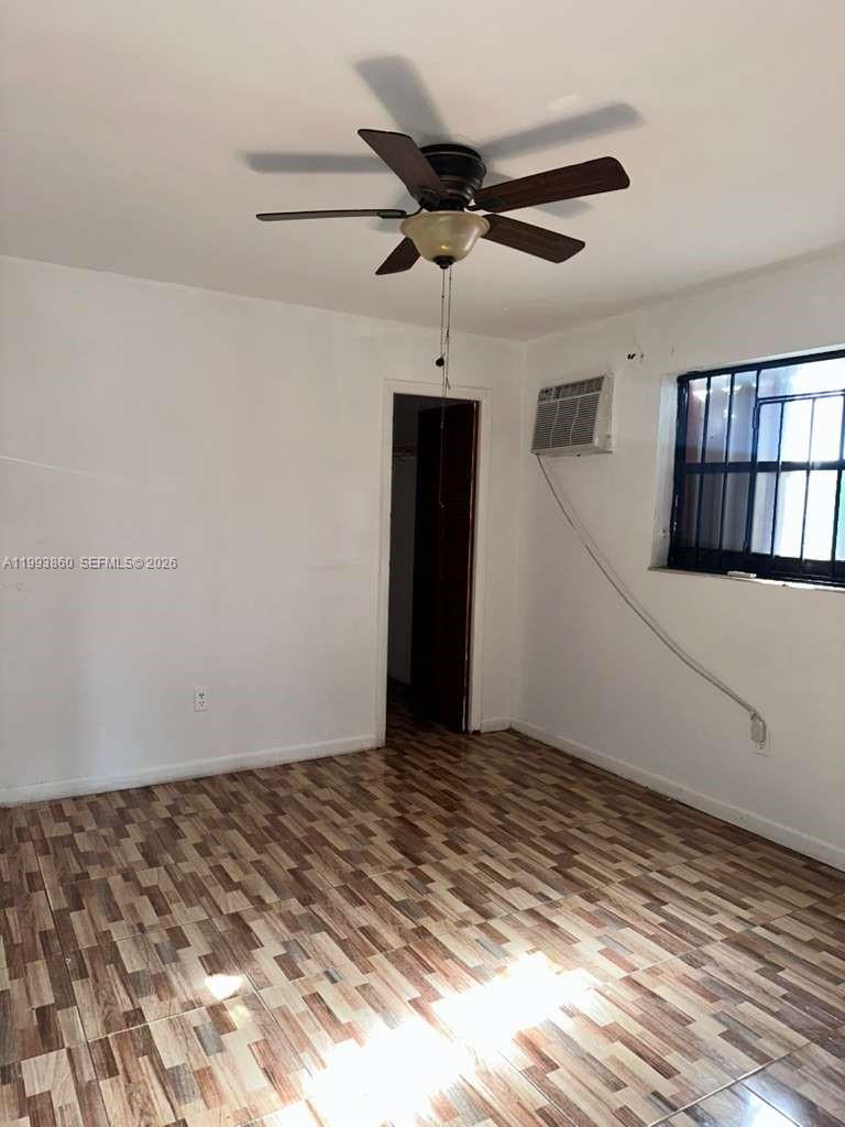 576 Northwest 147th Street, Unit 576 Miami, FL 33168 - Photo 4 of 18 a view of a big room with wooden floor and windows