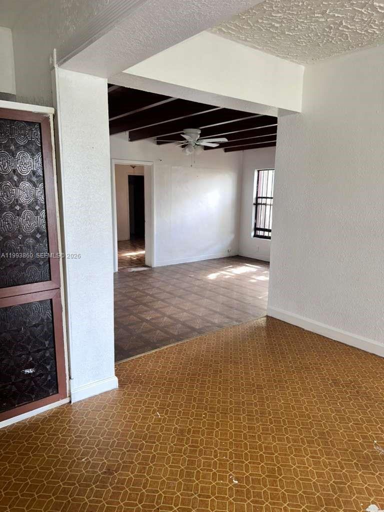576 Northwest 147th Street, Unit 576 Miami, FL 33168 - Photo 10 of 18 an empty room with wooden floor and windows