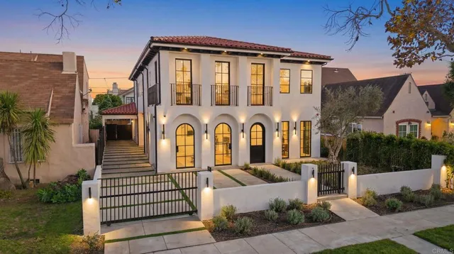 a front view of a house with a garden
