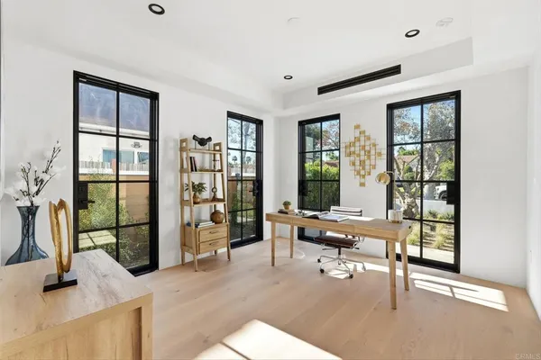 a living room with furniture and large windows