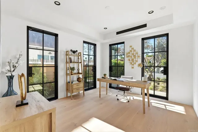 a living room with furniture and large windows