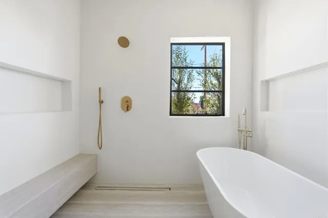 a bathroom with a tub and window